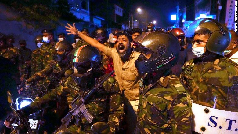 Sri Lanka imposed a curfew, and confrontations hurt 20
